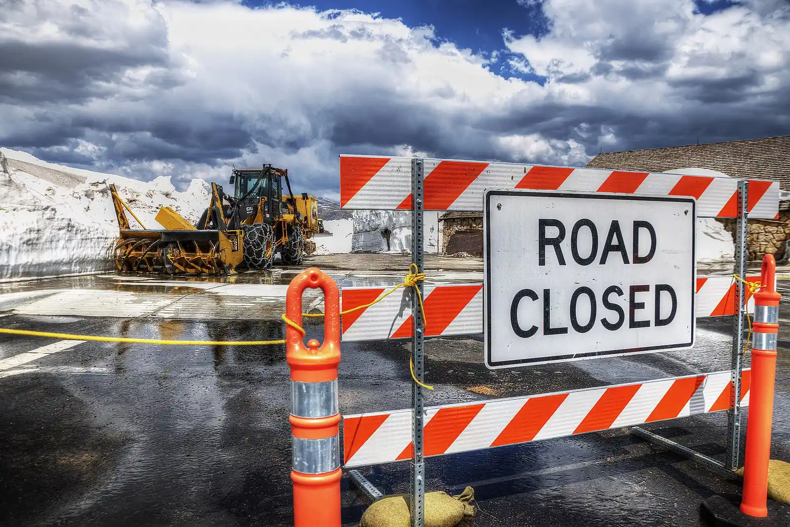 Road closed sign and deep snowdrifts at Alpine Visitor Center on Trail Ridge Road